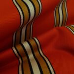 Gabardén oranžový s pruhy tuhý