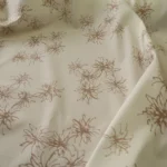 Popelín vanilkově žlutý s hnědými stylizovanými květy